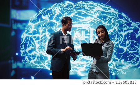 Coworkers using AI neural networks modeled after human brain, brainstorming ways to solve complex problems. IT department staff members using deep learning to look at data and complete tasks, camera B Coworkers using AI neural networks modeled after human brain, brainstorming ways to solve complex problems. IT department staff members using deep learning to look at data and complete tasks, camera B 118603815