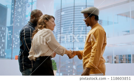 Skilled realtor salesman greeting business people for an office tour, examining new corporation workspace in an urban high class building. Development with real estate investment strategy. Camera A. Skilled realtor salesman greeting business people for an office tour, examining new corporation workspace in an urban high class building. Development with real estate investment strategy. Camera A. 118603851
