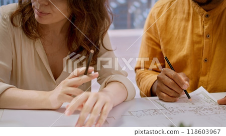 Entrepreneur and real estate agent evaluate investment opportunities by studying blueprints, planning a new high class office layout. Business people meeting realtor financier. Camera A. 118603967