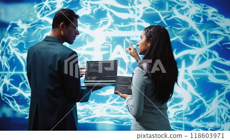 Programmers using devices and AI neural networks modeled after human brain to solve complex problems. Workers using artificial intelligence deep learning to look at data and complete tasks, camera B Programmers using devices and AI neural networks modeled after human brain to solve complex problems. Workers using artificial intelligence deep learning to look at data and complete tasks, camera B 118603971