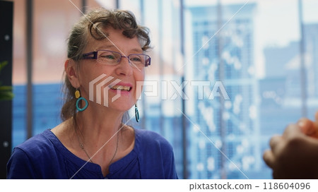 Elderly couple consulting with a financial advisor to explore beneficial retirement plans, securing life savings and pension planning. Looking into banking options for finances. Camera A. 118604096