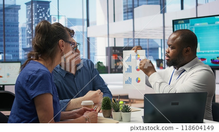 Mature couple asking for professional financial advice from banker expert, discussing strategy for retirement planning using their family expenses and savings. Investment plan. Camera B. Mature couple asking for professional financial advice from banker expert, discussing strategy for retirement planning using their family expenses and savings. Investment plan. Camera B. 118604149