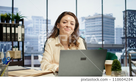 Portrait of determined female leader focuses on expanding the enterprise global footprint, using her knowledge of international markets and cultural awareness to drive business success. Camera B. Portrait of determined female leader focuses on expanding the enterprise global footprint, using her knowledge of international markets and cultural awareness to drive business success. Camera B. 118604284