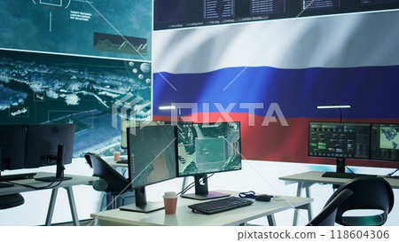 Empty mission control center with the russian flag on big screen, dealing with fake news and a terrorist attack with high tech gear. Spreading misinformation and controlling the people. Camera B. 118604306