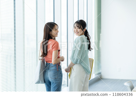 Female university students walking through a classroom. Photo courtesy of Denpa Gakuen, Tokyo Electronics College. 118604336