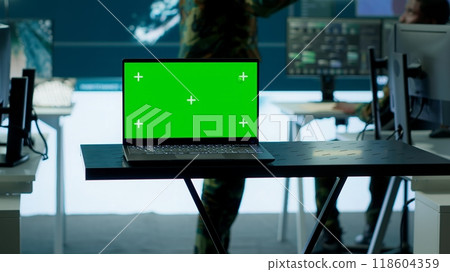 Cybersecurity team operates in an advanced military command center, surveillance systems and data protection. Army personnel work on national security operations using high tech gear. Camera B. 118604359
