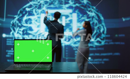 Startup coworkers using AI software on chroma key notebook to take data driven decisions. Close up of isolated screen laptop used for developing artificial intelligence solutions, camera B 118604424