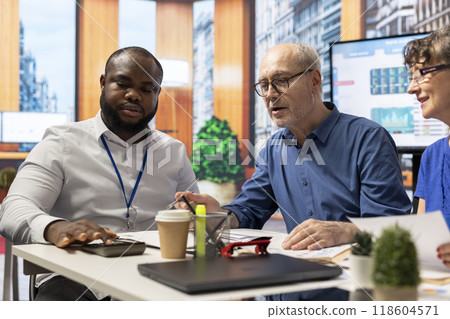 Senior citizens meeting with financial broker to explore various retirement options and secure their pension. Detailed consultation with an expert about life savings and insurance. Senior citizens meeting with financial broker to explore various retirement options and secure their pension. Detailed consultation with an expert about life savings and insurance. 118604571