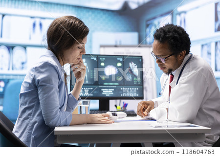 General practitioner taking the oxygen saturation and vital signs for a patient, using oximeter and other diagnostic tools in cabinet office. Male specialist consulting a woman, healthcare services. 118604763