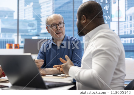 Elderly couple meeting with a financial expert to develop a tailored retirement strategy and covering future savings. Discussing plans for investment opportunities and long term financial goals. 118605143