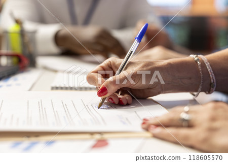 Elderly woman giving her signature on retirement plan contract, choosing the suitable pension option with life insurance policy to secure the future income and family expenses. Close up. Elderly woman giving her signature on retirement plan contract, choosing the suitable pension option with life insurance policy to secure the future income and family expenses. Close up. 118605570