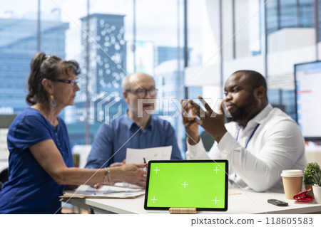 Financial expert counseling senior citizens to discuss insurance policy, having chroma key on tablet and choosing a suitable retirement plan. Mature man and woman investing life savings. 118605583