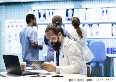 Professional medical team examine hospital records and treatment outcomes in a clinic to ensure quality insurance services. Physician specialist analyzing test results for expert solutions. Professional medical team examine hospital records and treatment outcomes in a clinic to ensure quality insurance services. Physician specialist analyzing test results for expert solutions. 118605602