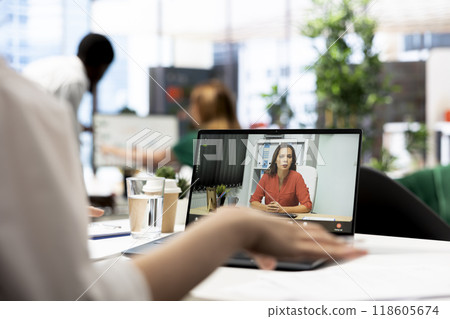 HR manager interviewing woman during remote videocall after doing background checks. HR professional discussing with candidate for vacant startup business position during teleconference meeting HR manager interviewing woman during remote videocall after doing background checks. HR professional discussing with candidate for vacant startup business position during teleconference meeting 118605674