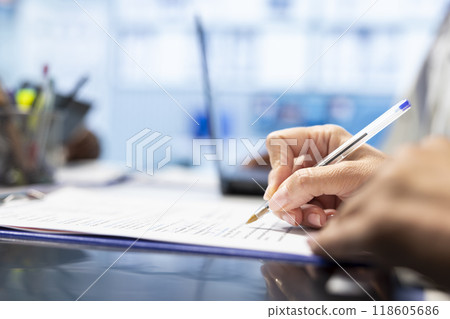 Physician writing a prescription treatment plan to help with recovery, recommending a suitable healthcare strategy based on radiography results and hospital records. Medicare meeting. Close up. 118605686