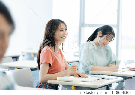 Female university students taking classes in a classroom. Photo courtesy of Denpa Gakuen, Tokyo Electronics College. 118606303