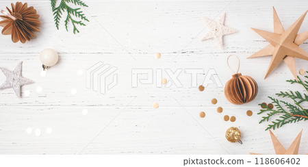 Festive Christmas background with gift box and Christmas decorations on white wooden table. Top view. Copy space for text. Festive Christmas background with gift box and Christmas decorations on white wooden table. Top view. Copy space for text. 118606402