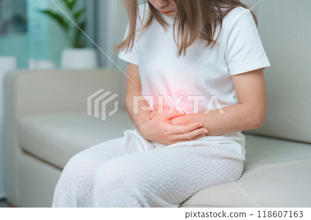 woman having abdomen ache due to Stomach pain, digestion with constipation or Diarrhea from food poisoning, female problem and Endometriosis, Hysterectomy, Stomachache and Menstrual on sofa at home woman having abdomen ache due to Stomach pain, digestion with constipation or Diarrhea from food poisoning, female problem and Endometriosis, Hysterectomy, Stomachache and Menstrual on sofa at home 118607163