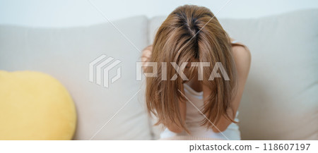 Stress, Sad and unhappy concepts. Alone asian Woman having headache, Young female feeling frustrated, exhausted and suffering 118607197