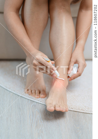 Arthritis and Muscle Pain Relief Cream concept. woman having leg pain due to Ankle Sprains or Achilles Tendonitis and Shin Splints ache. injuries, health and medical concept 118607202