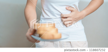 Gluten intolerance, Gluten free and celiac disease or wheat allergy concept. woman hold Bread and having abdominal pain after eat gluten. stomach ache, Nausea, Bloating, Gas, Diarrhea and Skin rash 118607232