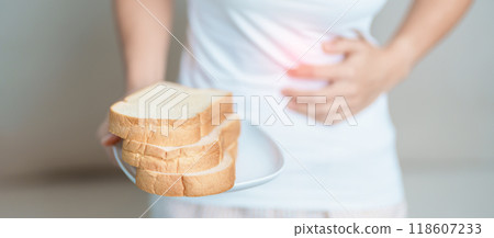 Gluten intolerance, Gluten free and celiac disease or wheat allergy concept. woman hold Bread and having abdominal pain after eat gluten. stomach ache, Nausea, Bloating, Gas, Diarrhea and Skin rash 118607233