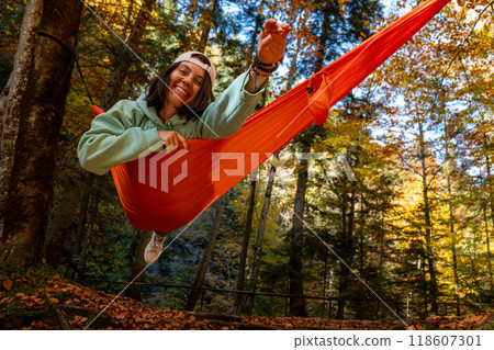 Relaxing in a Hammock in Autumn Forest Relaxing in a Hammock in Autumn Forest 118607301