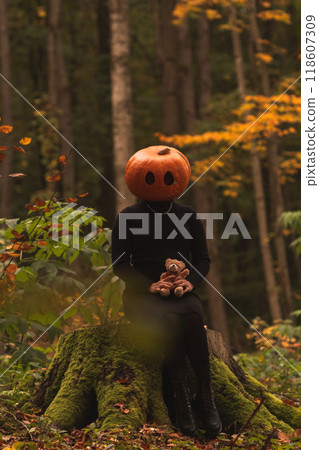 Surreal Pumpkin Head in Autumn Forest 118607309