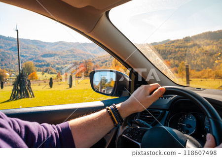 Man Driving Through Autumn Landscape Man Driving Through Autumn Landscape 118607498