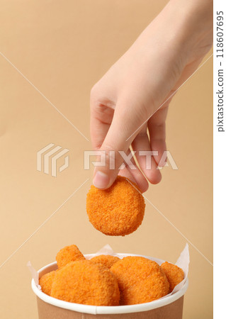 Fried mozzarella in a cardboard box on a beige background 118607695