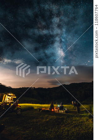 Campfire at night with stars and the Milky Way in the sky. Campfire at night with stars and the Milky Way in the sky. 118607764