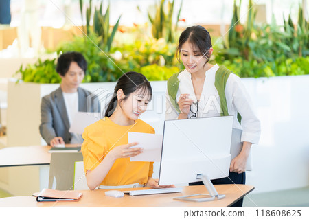 A young businesswoman working in an office. Photo courtesy of Denpa Gakuen, Tokyo Electronics College. 118608625