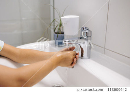 Little girl wash hand after school. White and clean bathroom Little girl wash hand after school. White and clean bathroom 118609642