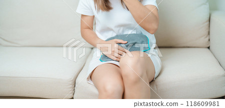 Menstruation period cycle of monthly and Stomachache concepts. woman having abdomen pain and menstrual ache with hot water bottle, illness female suffer from premenstrual ache and body Health problem 118609981