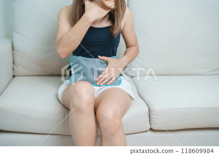 Menstruation period cycle of monthly and Stomachache concepts. woman having abdomen pain and menstrual ache with hot water bottle, illness female suffer from premenstrual ache and body Health problem 118609984