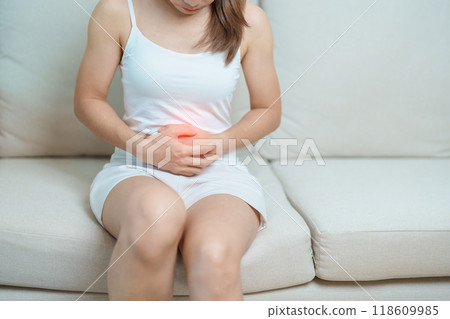 woman having abdomen ache due to Stomach pain, digestion with constipation or Diarrhea from food poisoning, female problem and Endometriosis, Hysterectomy, Stomachache and Menstrual on sofa at home woman having abdomen ache due to Stomach pain, digestion with constipation or Diarrhea from food poisoning, female problem and Endometriosis, Hysterectomy, Stomachache and Menstrual on sofa at home 118609985