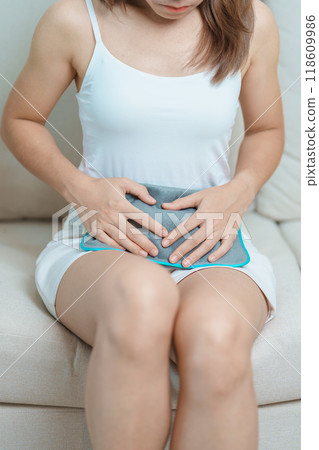 Menstruation period cycle of monthly and Stomachache concepts. woman having abdomen pain and menstrual ache with hot water bottle, illness female suffer from premenstrual ache and body Health problem 118609986