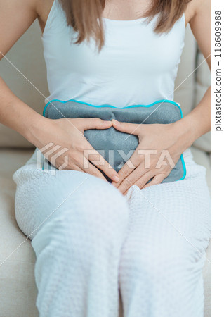 Menstruation period cycle of monthly and Stomachache concepts. woman having abdomen pain and menstrual ache with hot water bottle, illness female suffer from premenstrual ache and body Health problem 118609988