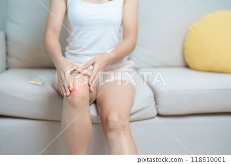 Arthritis and Muscle Pain Relief Cream concept. woman having knee ache and muscle pain due to Runners Knee or Patellofemoral Pain Syndrome, osteoarthritis, rheumatism and Patellar Tendinitis 118610001