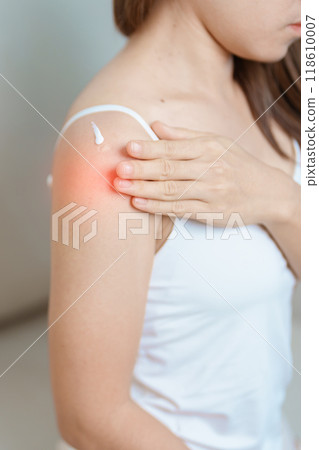 Arthritis and Muscle Pain Relief Cream concept. Woman having Shoulder and Arm pain at home. Muscle painful due to Myofascial pain syndrome and Fibromyalgia, rheumatism, Scapular pain, Cervical Spine 118610007