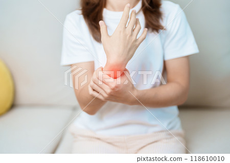 Woman having wrist pain at home, muscle ache due to De Quervain s tenosynovitis, ergonomic, Carpal Tunnel Syndrome or Office syndrome and Parkinson disease concept 118610010