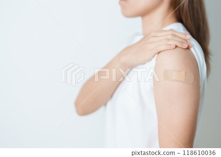 Woman with bandage after receiving vaccine. Vaccination and Immunization for Influenza, HPV, Zoster, IPD, DTP or Diphtheria, Tetanus and Pertussis, MMR, Hepatitis B, Covid  and Varicella vaccine 118610036