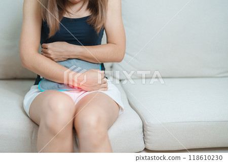 Menstruation period cycle of monthly and Stomachache concepts. woman having abdomen pain and menstrual ache with hot water bottle, illness female suffer from premenstrual ache and body Health problem 118610230