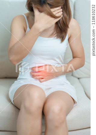 woman having abdomen ache due to Stomach pain, digestion with constipation or Diarrhea from food poisoning, female problem and Endometriosis, Hysterectomy, Stomachache and Menstrual on sofa at home woman having abdomen ache due to Stomach pain, digestion with constipation or Diarrhea from food poisoning, female problem and Endometriosis, Hysterectomy, Stomachache and Menstrual on sofa at home 118610232