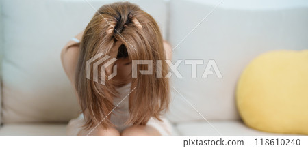 Stress, Sad and unhappy concepts. Alone asian Woman having headache, Young female feeling frustrated, exhausted and suffering 118610240