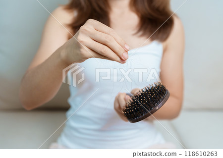 Hair loss problem, Balding , Beauty treatments and health care concepts asian woman holding holding comb with hair loss, young female hold hairbrush and brushing with fall hair from scalp Hair loss problem, Balding , Beauty treatments and health care concepts asian woman holding holding comb with hair loss, young female hold hairbrush and brushing with fall hair from scalp 118610263