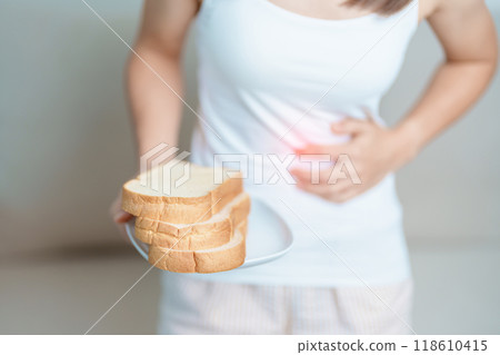 Gluten intolerance, Gluten free and celiac disease or wheat allergy concept. woman hold Bread and having abdominal pain after eat gluten. stomach ache, Nausea, Bloating, Gas, Diarrhea and Skin rash 118610415