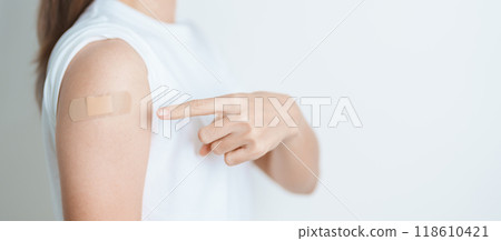 Woman with bandage after receiving vaccine. Vaccination and Immunization for Influenza, HPV, Zoster, IPD, DTP or Diphtheria, Tetanus and Pertussis, MMR, Hepatitis B, Covid  and Varicella vaccine 118610421