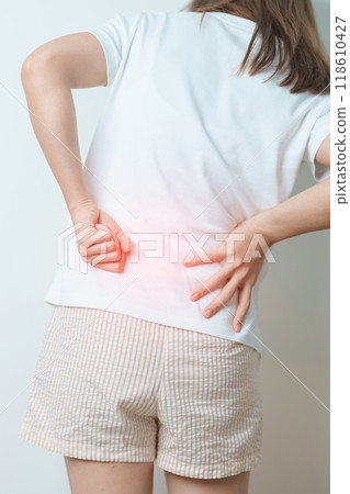 woman having back body ache during at home. adult female with muscle pain due to Piriformis Syndrome, Low Back Pain and Spinal Compression. Office syndrome and medical concept woman having back body ache during at home. adult female with muscle pain due to Piriformis Syndrome, Low Back Pain and Spinal Compression. Office syndrome and medical concept 118610427