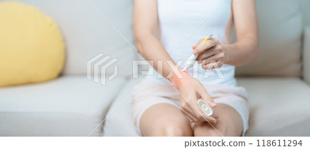 Arthritis and Muscle Pain Relief Cream concept. Woman having wrist pain at home, muscle ache due to De Quervain s tenosynovitis, ergonomic, Carpal Tunnel Syndrome or Office syndrome and Parkinson Arthritis and Muscle Pain Relief Cream concept. Woman having wrist pain at home, muscle ache due to De Quervain s tenosynovitis, ergonomic, Carpal Tunnel Syndrome or Office syndrome and Parkinson 118611294